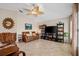 Living room with leather sofa and large TV at 4264 Wordsworth Way, Venice, FL 34293