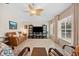Living room with leather sofa and large TV at 4264 Wordsworth Way, Venice, FL 34293