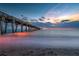Stunning sunset view over the ocean with a pier extending into the water at 4264 Wordsworth Way, Venice, FL 34293