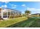 Inviting pool area with a screened enclosure and lush landscaping at 4264 Wordsworth Way, Venice, FL 34293