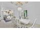 Bright dining room with white table and chairs, looking out onto a pool and patio at 436 Hoffer St, Port Charlotte, FL 33953