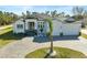 White two-story house with a three-car garage and paver driveway at 436 Hoffer St, Port Charlotte, FL 33953