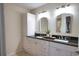 Double vanity bathroom with granite counters and large mirrors at 4619 Forest Wood Trl # 7, Sarasota, FL 34241