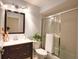 Updated bathroom with dark vanity, shower and a plant at 4619 Forest Wood Trl # 7, Sarasota, FL 34241