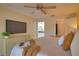 King-size bedroom with large TV and ensuite bath at 4619 Forest Wood Trl # 7, Sarasota, FL 34241