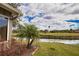 Landscaped backyard with golf course and water views at 4619 Forest Wood Trl # 7, Sarasota, FL 34241