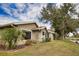 Side view showcasing home's exterior and landscaping at 4619 Forest Wood Trl # 7, Sarasota, FL 34241