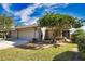 Attractive exterior of a single-story home with a well-maintained lawn and landscaping at 4619 Forest Wood Trl # 7, Sarasota, FL 34241