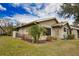 Exterior view of home with lush landscaping and golf course view at 4619 Forest Wood Trl # 7, Sarasota, FL 34241