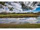 Peaceful view of a golf course and water feature at 4619 Forest Wood Trl # 7, Sarasota, FL 34241