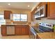 Kitchen with stainless steel sink, granite countertops, and golf course view at 4619 Forest Wood Trl # 7, Sarasota, FL 34241