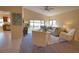 Living room features large windows and neutral decor at 4619 Forest Wood Trl # 7, Sarasota, FL 34241