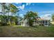 Spacious backyard with grassy area and screened pool enclosure at 4695 W Price Blvd, North Port, FL 34286