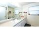 Clean bathroom with a large mirror and white vanity at 4695 W Price Blvd, North Port, FL 34286