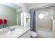 Bathroom with a polka dot shower curtain and white vanity at 4695 W Price Blvd, North Port, FL 34286