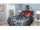 Bedroom with a black and white comforter and a nightstand at 4695 W Price Blvd, North Port, FL 34286