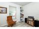 Bright bonus room features a comfy chair, built-in shelving, and vinyl flooring at 4695 W Price Blvd, North Port, FL 34286
