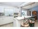 White kitchen with a breakfast bar and mosaic backsplash at 4695 W Price Blvd, North Port, FL 34286