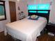 Main bedroom with a double bed and a teal closet at 476 Boxwood Dr, Venice, FL 34285