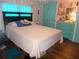 Main bedroom with double bed, light pink walls, and teal closet at 476 Boxwood Dr, Venice, FL 34285
