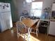 Bright dining area with wood table and white chairs at 476 Boxwood Dr, Venice, FL 34285
