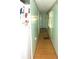 Long hallway with light green walls and wood flooring at 476 Boxwood Dr, Venice, FL 34285