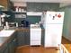 Kitchen with green cabinets and white appliances at 476 Boxwood Dr, Venice, FL 34285