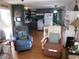 Open concept kitchen and living room with light wood floors, and comfy armchairs at 476 Boxwood Dr, Venice, FL 34285