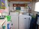 Bright laundry room with washer, dryer, and ample storage at 476 Boxwood Dr, Venice, FL 34285