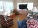 Relaxing living room with rocking chairs and large TV at 476 Boxwood Dr, Venice, FL 34285