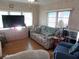 Living room featuring a large TV and comfy seating at 476 Boxwood Dr, Venice, FL 34285