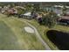 Aerial view of a house with a pool near a golf course at 487 Summerfield Way, Venice, FL 34292