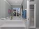 Bathroom with large soaking tub, walk-in shower, and window at 487 Summerfield Way, Venice, FL 34292