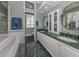 Elegant bathroom with double sinks, green marble countertops, and large mirror at 487 Summerfield Way, Venice, FL 34292