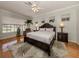 Primary bedroom with hardwood floors, large windows, and ceiling fan at 487 Summerfield Way, Venice, FL 34292