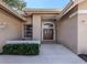 Front entrance with double doors and landscaping at 487 Summerfield Way, Venice, FL 34292
