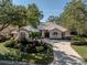 Beautiful home with lush landscaping and a large driveway at 487 Summerfield Way, Venice, FL 34292