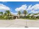 Community clubhouse with palm trees and landscaping at 487 Summerfield Way, Venice, FL 34292