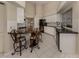 Kitchen with granite breakfast bar and white cabinets at 487 Summerfield Way, Venice, FL 34292