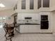 White kitchen with granite countertops and black appliances at 487 Summerfield Way, Venice, FL 34292
