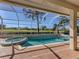 Inviting pool and spa with a screened enclosure and golf course view at 487 Summerfield Way, Venice, FL 34292