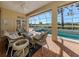 Relaxing pool patio with wicker furniture, overlooking the pool and golf course at 487 Summerfield Way, Venice, FL 34292