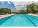 Community pool with lounge chairs and a cabana at 487 Summerfield Way, Venice, FL 34292