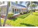 Landscaped backyard with a screened pool and lush tropical plants at 49 Perimeter Dr, Englewood, FL 34223