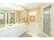 Large bathroom with double vanities, a soaking tub, and a shower at 49 Perimeter Dr, Englewood, FL 34223