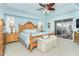 Spacious Primary bedroom with wood furniture and sliding glass doors to backyard at 49 Perimeter Dr, Englewood, FL 34223