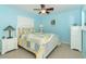 Cozy bedroom with white furniture and light blue walls at 49 Perimeter Dr, Englewood, FL 34223