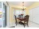 Bright breakfast nook with a round table and four chairs, near the pool at 49 Perimeter Dr, Englewood, FL 34223