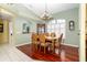 Bright dining room with hardwood floors, chandelier and large window at 49 Perimeter Dr, Englewood, FL 34223