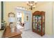 Entryway with hardwood floors, console table and china cabinet at 49 Perimeter Dr, Englewood, FL 34223